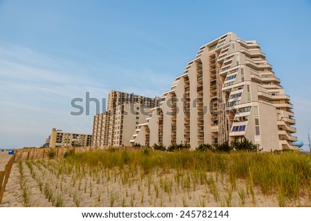 OCEAN CITY - August 8:View of sand dunes and beachfront hotel in Ocean City, MD on August 8, 2014. Ocean City, MD is a popular beach resort on the East Coast and it is one of the cleanest in USA.