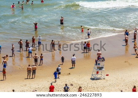 OCEAN CITY - JUNE 14: Tourists at the beach in Ocean City, MD on June 14, 2014. Ocean City, MD is a popular beach resort on the East Coast and it is one of the cleanest in the country.