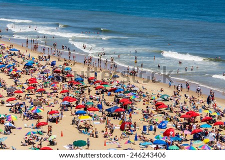 OCEAN CITY - JUNE 14: Crowded beach covered with umbrellas in Ocean City, MD on June 14, 2014. Ocean City, MD is a popular beach resort on the East Coast and one of the cleanest in the country.
