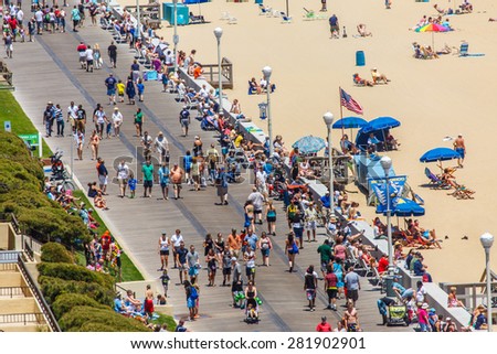 OCEAN CITY - JUNE 14: Tourists at the boardwalk in Ocean City, MD on June 14, 2014. Ocean City, MD is a popular beach resort on the East Coast and it is one of the cleanest in the country.