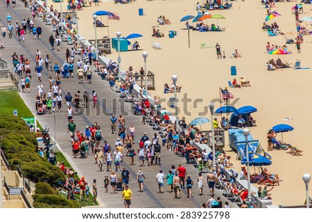 OCEAN CITY - JUNE 14: Tourists at the boardwalk in Ocean City, MD on June 14, 2014. Ocean City, MD is a popular beach resort on the East Coast and it is one of the cleanest in the country.
