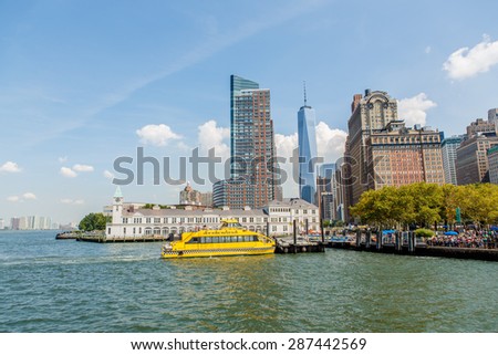 NEW YORK - AUGUST 2014: Office buildings in Manhattan on August 11, 2014 with the NY water taxi in the foreground. NYWT offers sightseeing, charter and commuter services along East and Hudson River.