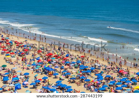 OCEAN CITY - JUNE 14: Tourists at the beach in Ocean City, MD on June 14, 2014. Ocean City, MD is a popular beach resort on the East Coast and it is one of the cleanest in the country.
