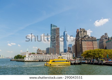 NEW YORK - AUGUST 2014: Office buildings in Manhattan on August 11, 2014 with the NY water taxi in the foreground. NYWT offers sightseeing, charter and commuter services along East and Hudson River.