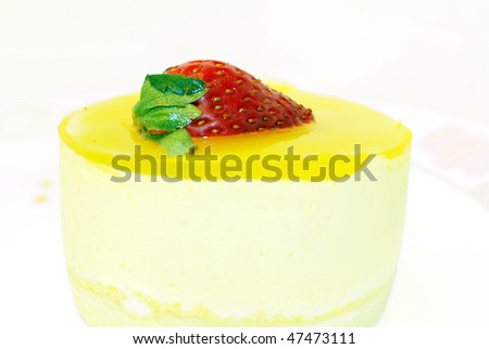 gourmet delicious mango mousse cake topped with a strawberry