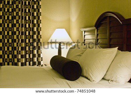 Luxurious bedroom with comfortable bed sets of fluffy pillows and fresh linens
