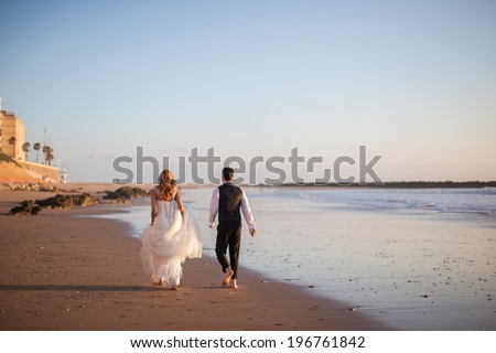 Happy bride and groom on a beautiful beach on sunset. Wedding Couple, Happy romantic bride and groom in love