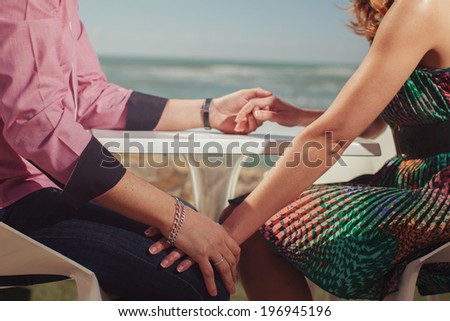 Attractive Young Couple on the Beach.  young couple holding hands