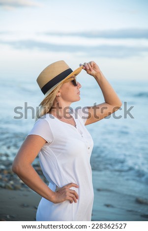 Young and beautiful woman in sunset light looking far away