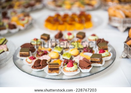 Rows of tasty looking desserts in beautiful arrangements. Sweets on banquet table - picture taken during catering event