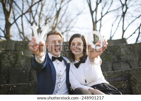 Closeup shot of young couple hands holding the word Love