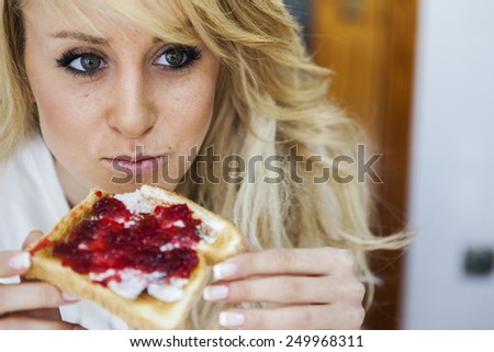 Young woman with marmalade toast. Selective soft focus