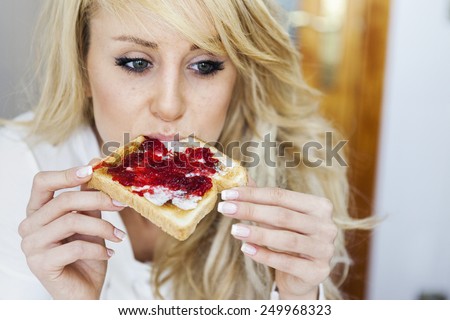 Young woman with marmalade toast. Selective soft focus