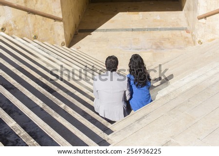 young couple sightseeing on steps