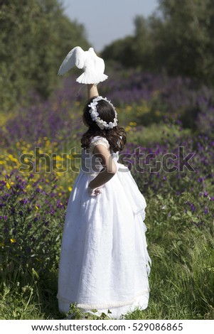 ute little girl on white dress and wreath on first holy communion