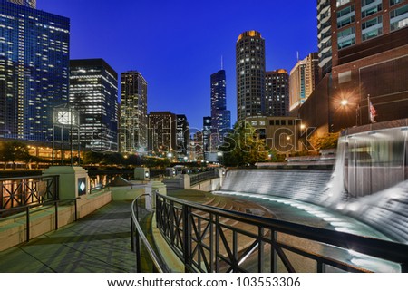 Floodlit Centennial Fountain and river side walk in Chicago at night
