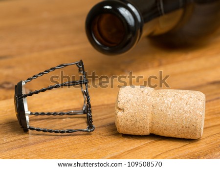 Champagne style cork and retaining cap by brown bottle of strong belgium ale beer