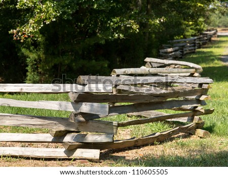 Traditional split rail fence by side of woods or forest