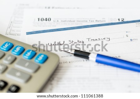 Tax form 1040 for tax year 2012 for US individual tax return with pen and check