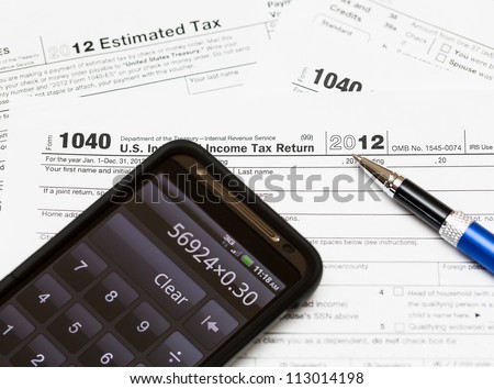 Tax form 1040 for tax year 2012 for US individual tax return with smartphone calculator