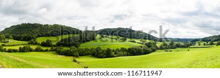 Broad panorama of the countryside in North Wales with green field in foreground