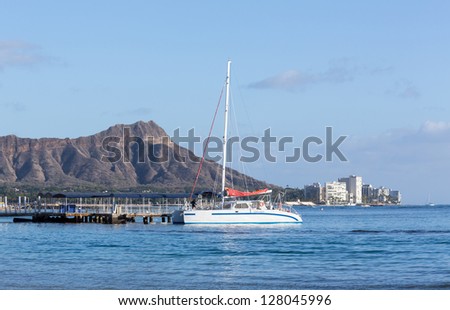 Boat docked in front of Diamond Head and Waikiki Beach area of Oahu in Hawaii