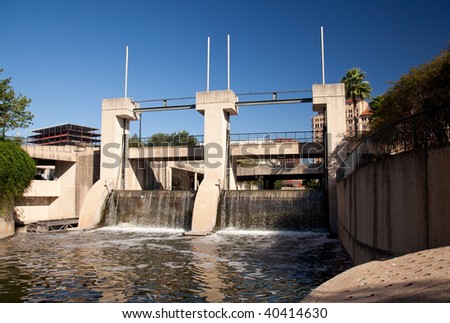 Concrete construction aimed at controlling flooding of San Antonio River and the walk