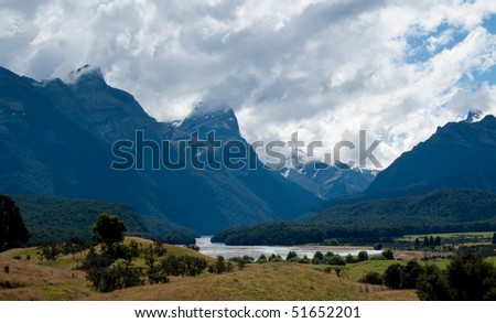 Rolling countryside valley in New Zealand with folded hills and mountains