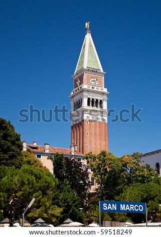 San Marco bell tower rises above the trees in Venice