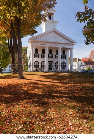 Autumnal shot of the Windham County Court House in fall as the bright trees turn orange and red