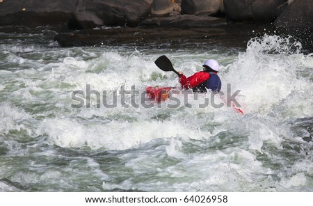 Canoeing in white water in rapids on river