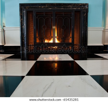 Logs burning in old fireplace in 19th century house