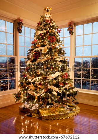 christmas tree with presents and lights. stock photo : Christmas tree with presents and lights reflecting in windows 