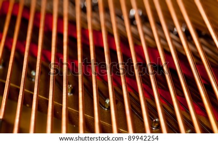 Close up image of interior of grand piano showing strings and structure
