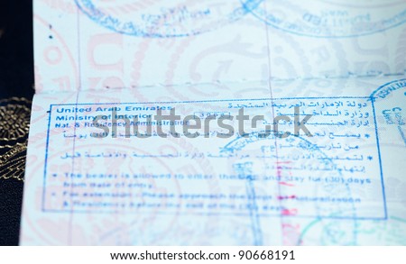 Macro image of visa and immigration stamps in US passport for Dubai or Abu Dhabi in the UAE