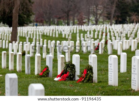 ARLINGTON, VA - DECEMBER 18: Christmas wreaths on gravestones in Arlington National Cemetery on December 18, 2011. The wreathes have been donated each year since 1992.