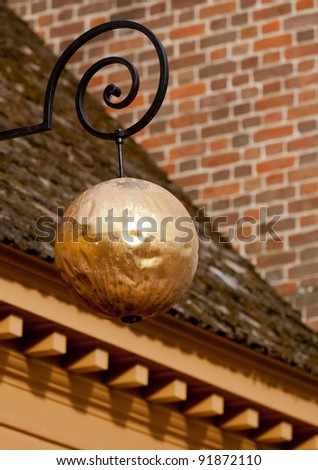 Golden sphere in front of old Jewelry shop
