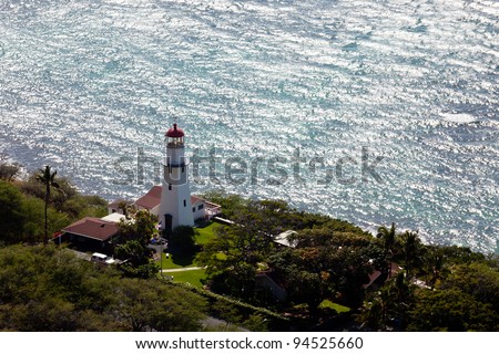 Lighthouse on coast under the summit of the old volcano of Diamond Head