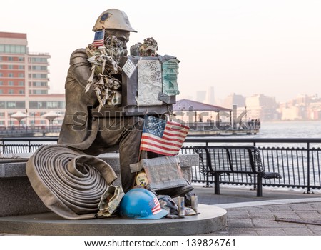 JERSEY CITY, NJ, USA - 22 MAY: Firefighter 9-11 Memorial Statue at Exchange Place on 22 May 2013. The statue was recovered from World Trade Center site and is by Seward Johnson