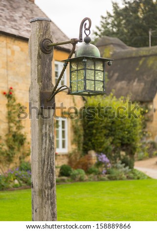 Street lamp in the village of Stanton near Stanway. Cotswold or Cotswolds district of southern England in the autumn.