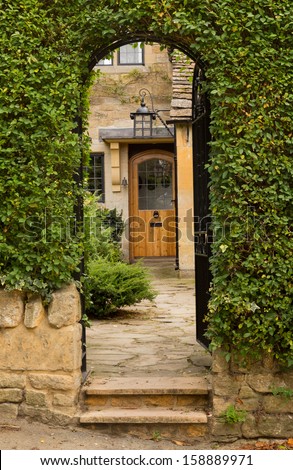 Entrance to front door of cottage in Stanton in Cotswold or Cotswolds district of southern England in the autumn.