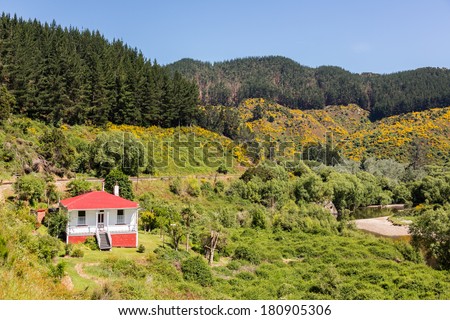 Railway track of Taieri Gorge tourist railway passes Parera station masters house on its journey up the valley