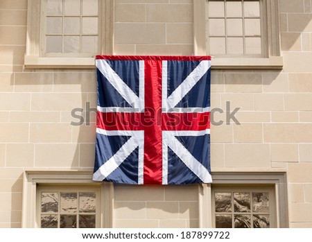 Old style English Flag hung outside historic Carlyle House in center of old town of Alexandria in Virginia USA