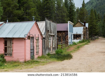 Old wooden houses line the main street of ghost town of St Elmo in Colorado