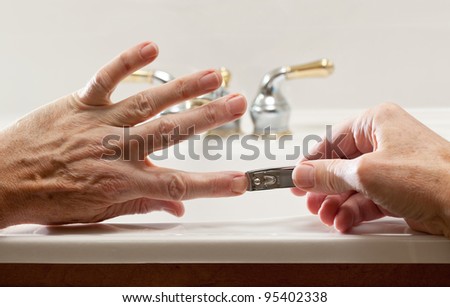 Finger nail clippings in palm of hand on bathroom sink