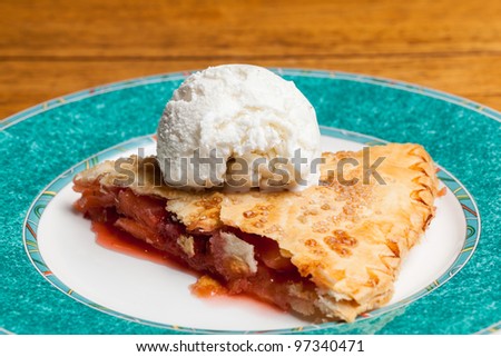 Home made baked fruit pie on plate in single serving with ice cream