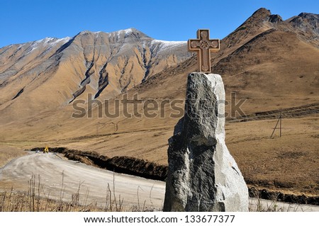 Cross on pedestal at Caucasus mountains in the district of Military-Georgian road. Georgia.