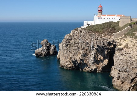Lighthouse at the background of clear blue sky and deep blue ocean