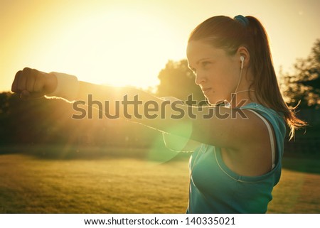 Doing sport in sunset / Young woman do sport on a play-ground