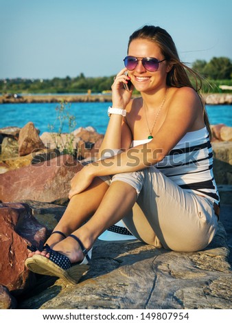 Call from the beach / Young woman make call from a beach on her holidays